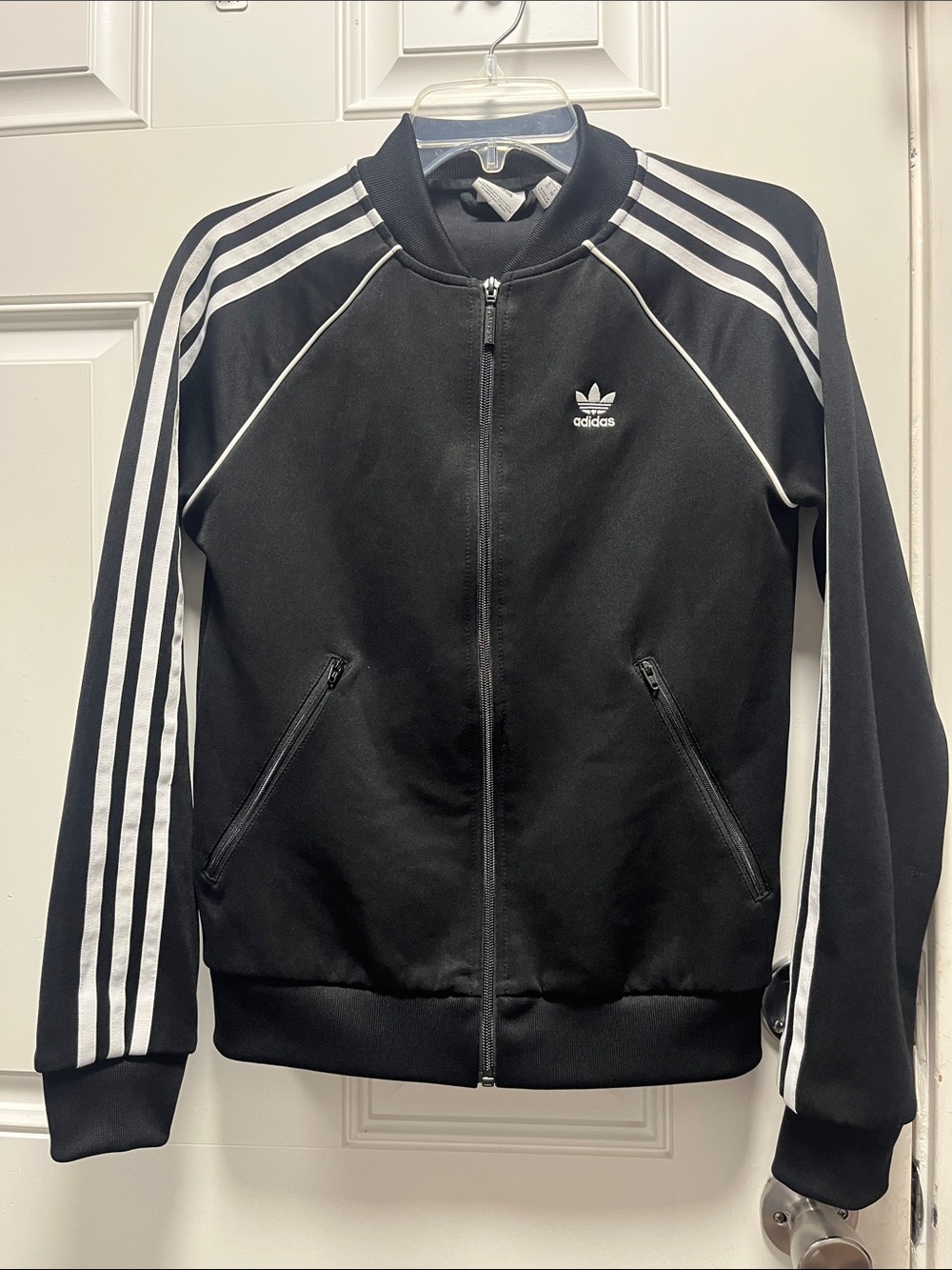 Classic adidas track jacket in black with stripe accents